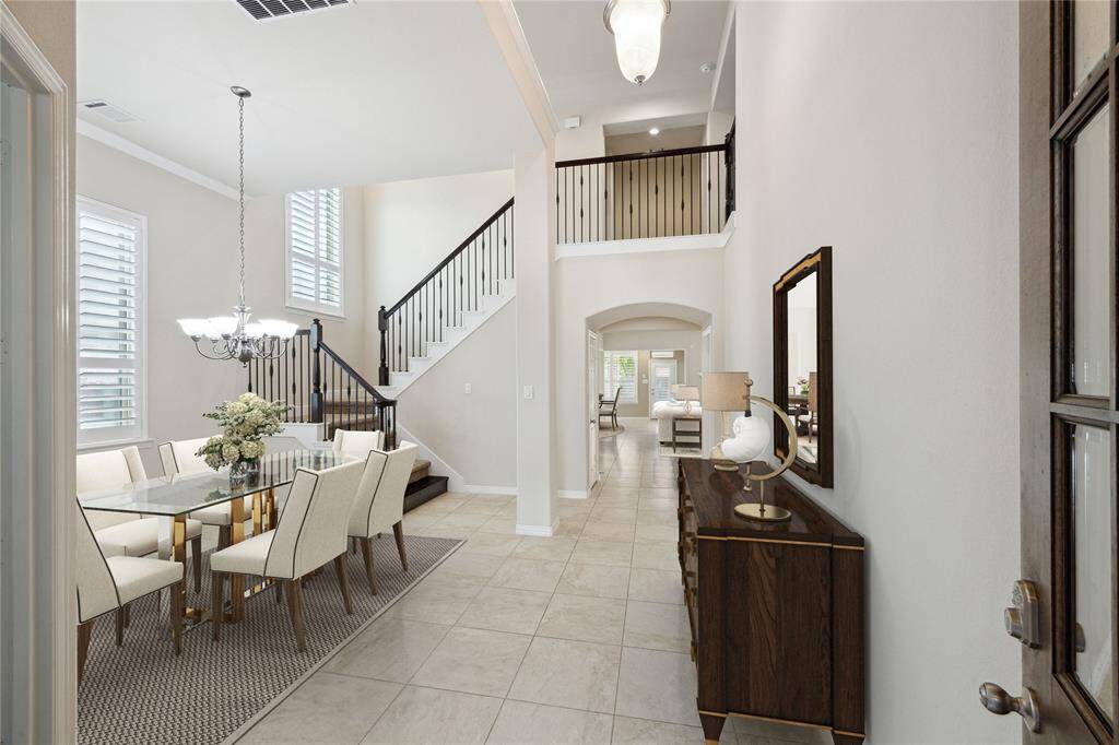 Impressive foyer with soaring ceilings, tile flooring and elegant staircase. Open Dining room (12x9) with flexible arrangement for large gatherings. Virtually staged.