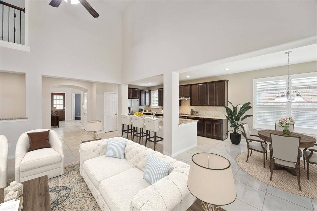 Another view from front door entry. 3,158 square feet per Brazoria County Appraisal District. Expansive open kitchen with breakfast bar seating, and family room layout. Recessed lighting and ceiling fan. Virtually staged.