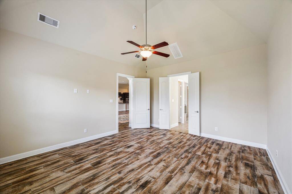 Spacious primary bedroom with abundant natural light.