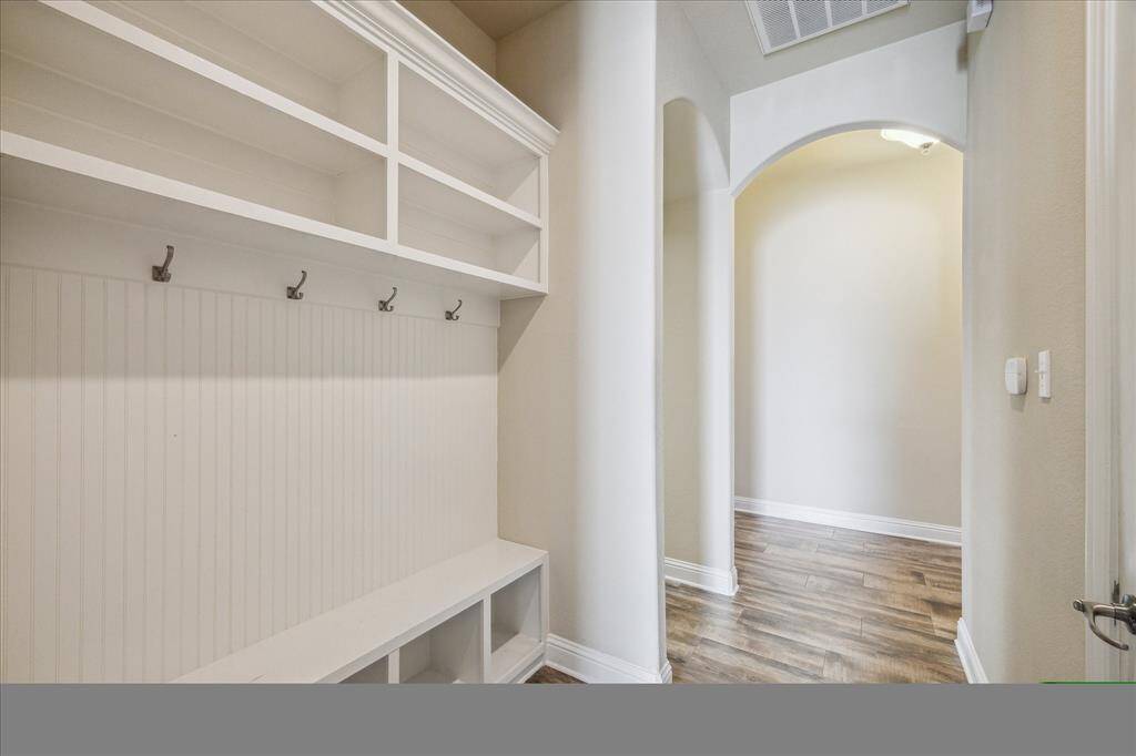Stylish mudroom with generous storage, conveniently situated by the garage entry.