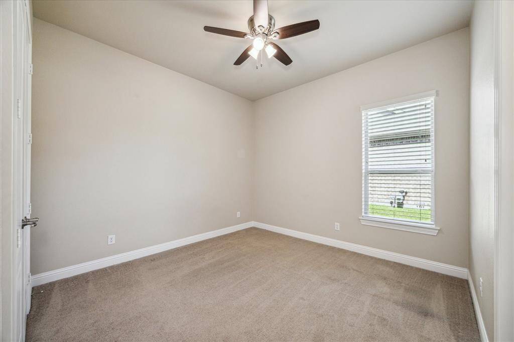 Cozy secondary bedroom with plush carpet and a generous walk-in closet.