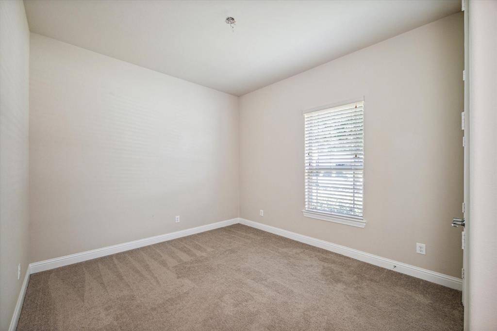 Inviting bedroom with plush carpet and a generous walk-in closet.