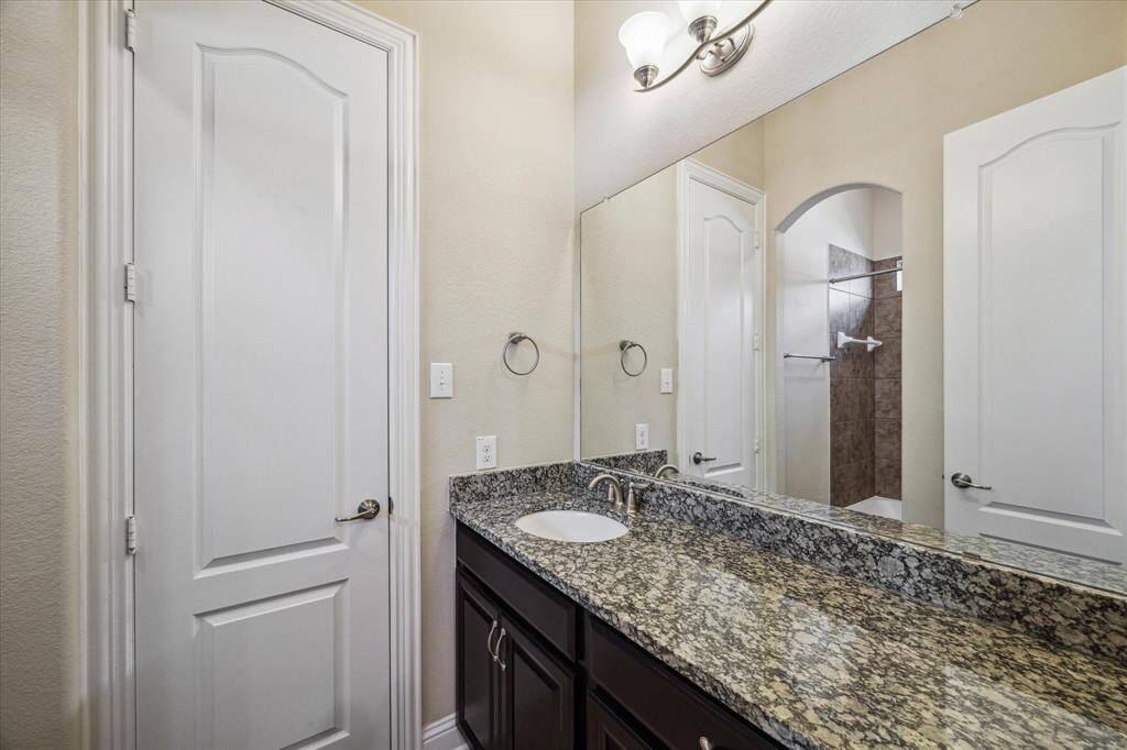 Secondary bath with granite vanity and full size mirror