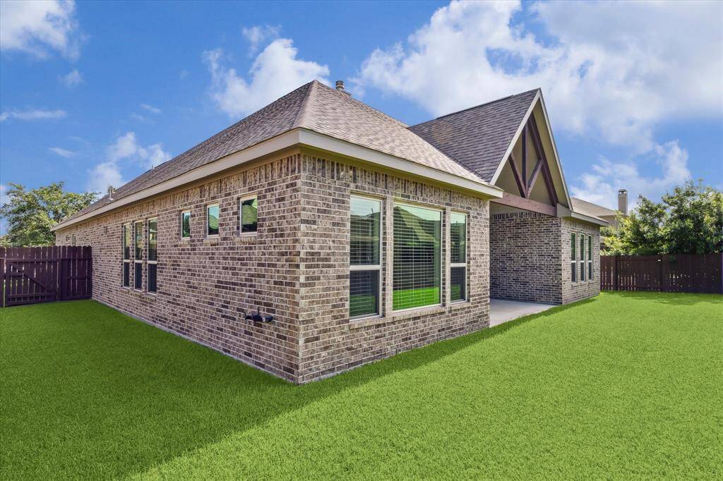 All-brick home with a covered patio and expansive yard, ideal for entertaining or a future pool!