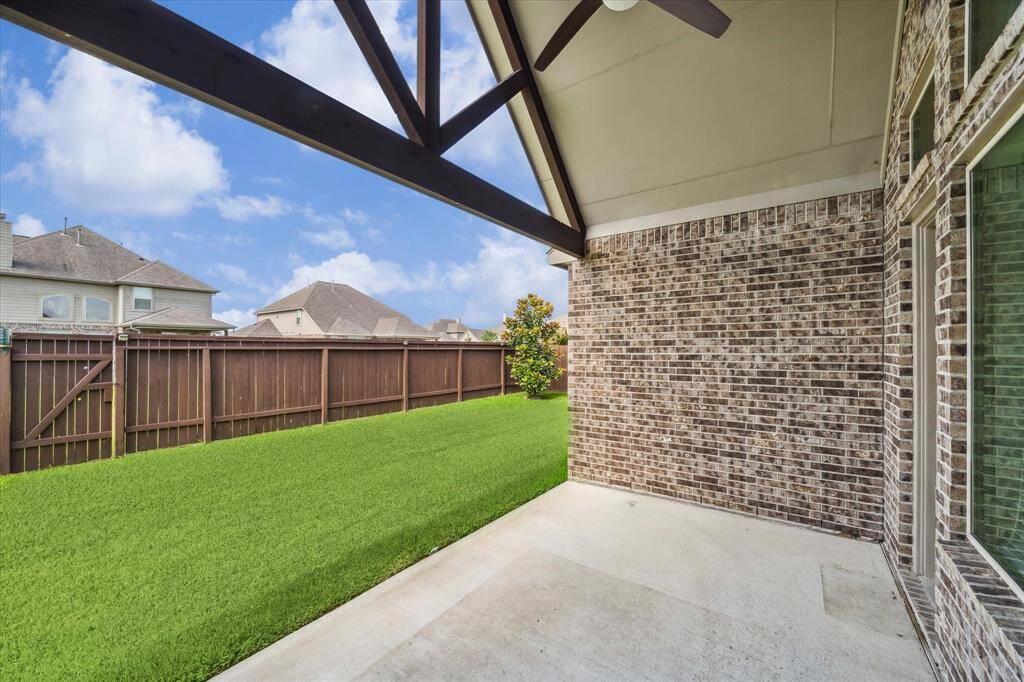 Experience the perfect breeze on this inviting covered patio, ideal for gatherings.