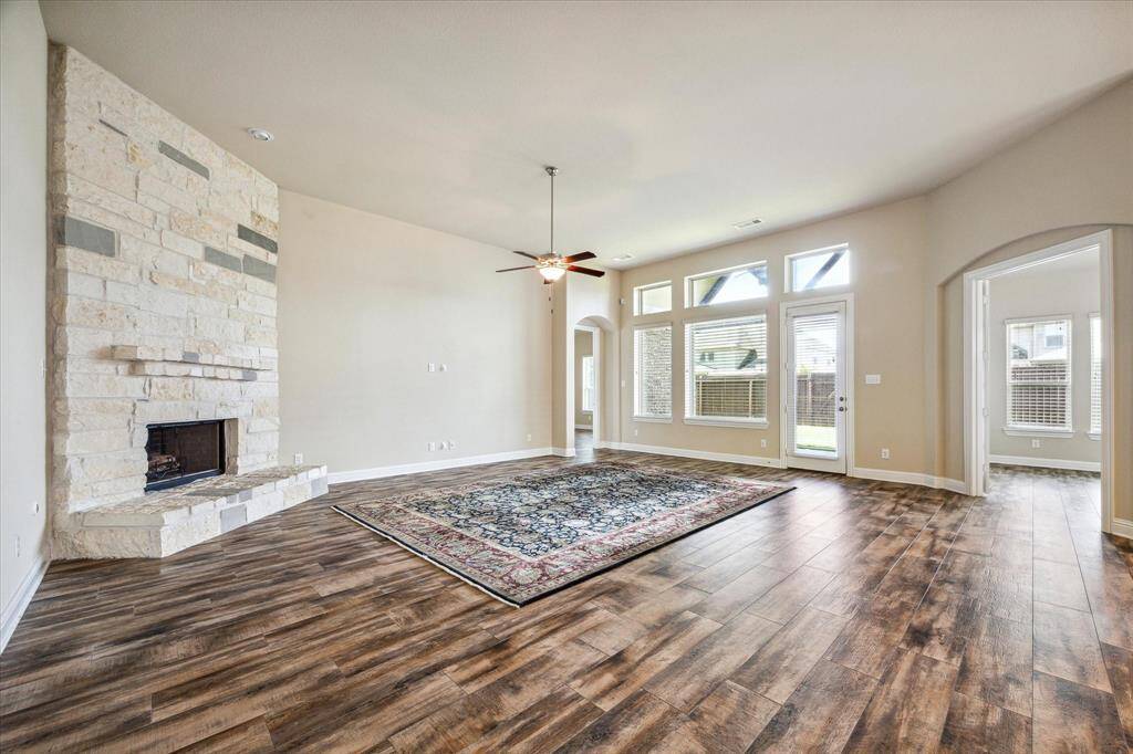 Expansive family room with stylish wood-look tile flooring.