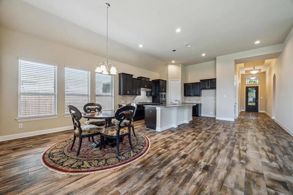 Discover the perfect blend of style and function with a seamless transition from the breakfast nook to the modern kitchen, ideal for dining and entertaining.
