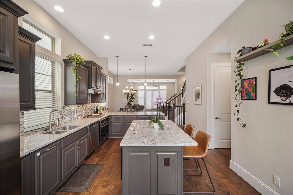 Open-concept kitchen seamlessly connects to dining and living areas, perfect for modern living.