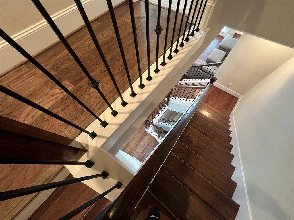 Exquisitely designed with metal railings that complement the beautifully crafted wood-trimmed stairs.