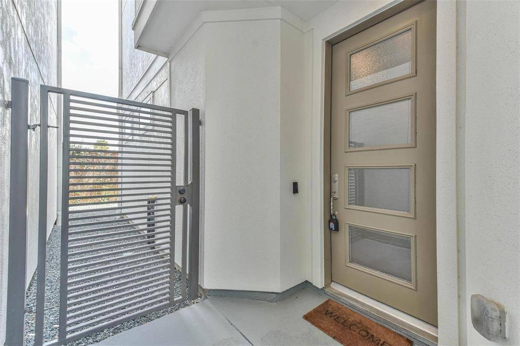 Sleek metal gate offering convenient backyard access, perfect for seamless entertaining.