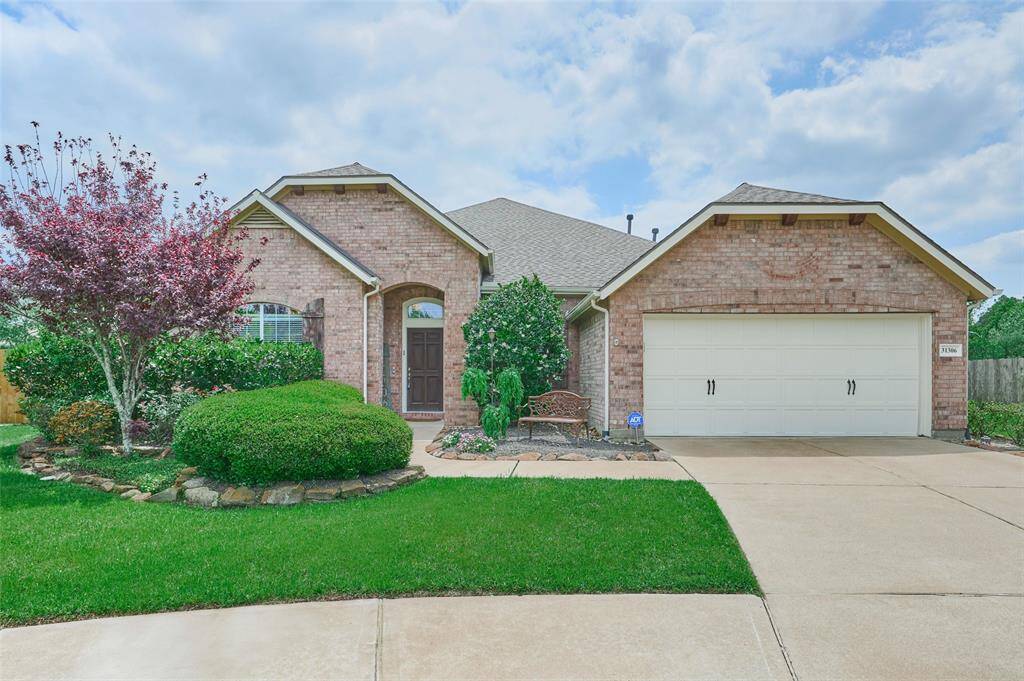 Pristine lawn with a 1.5-story home on a cul-de-sac.