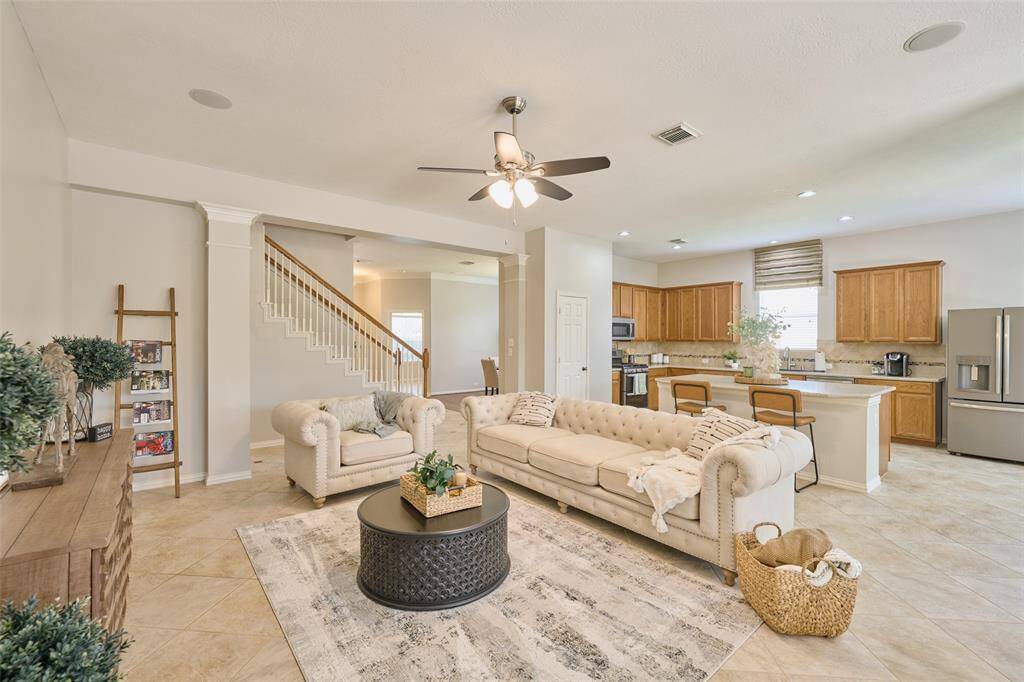 Another view of the family room, showcasing a small recessed wall and openness leading to the kitchen.
