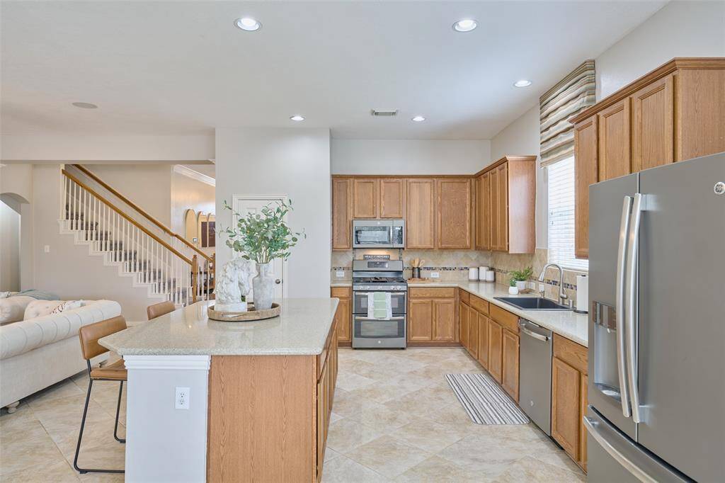 Another angle of the thoughtfully designed kitchen, showcasing the stainless steel appliances.