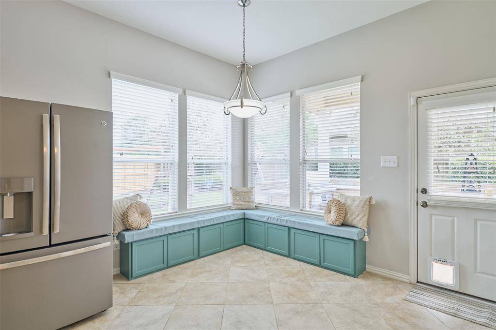 The breakfast nook, located adjacent to the kitchen, offers views of the custom outdoor kitchen.