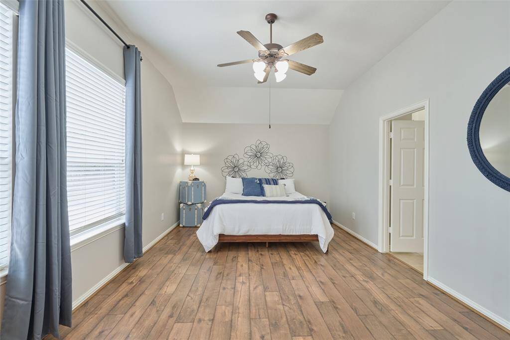 The primary bedroom is located at the back of the residence, featuring high ceilings and ample space.