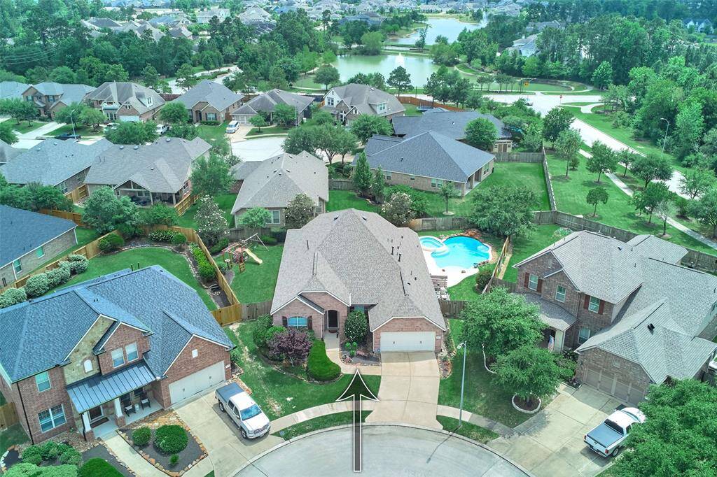 Aerial view showcasing the property, community lakes, and walking trails.