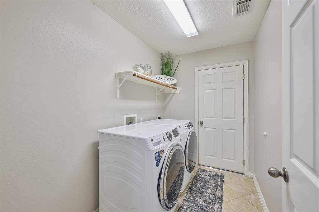 Ample utility room with access to the garage.