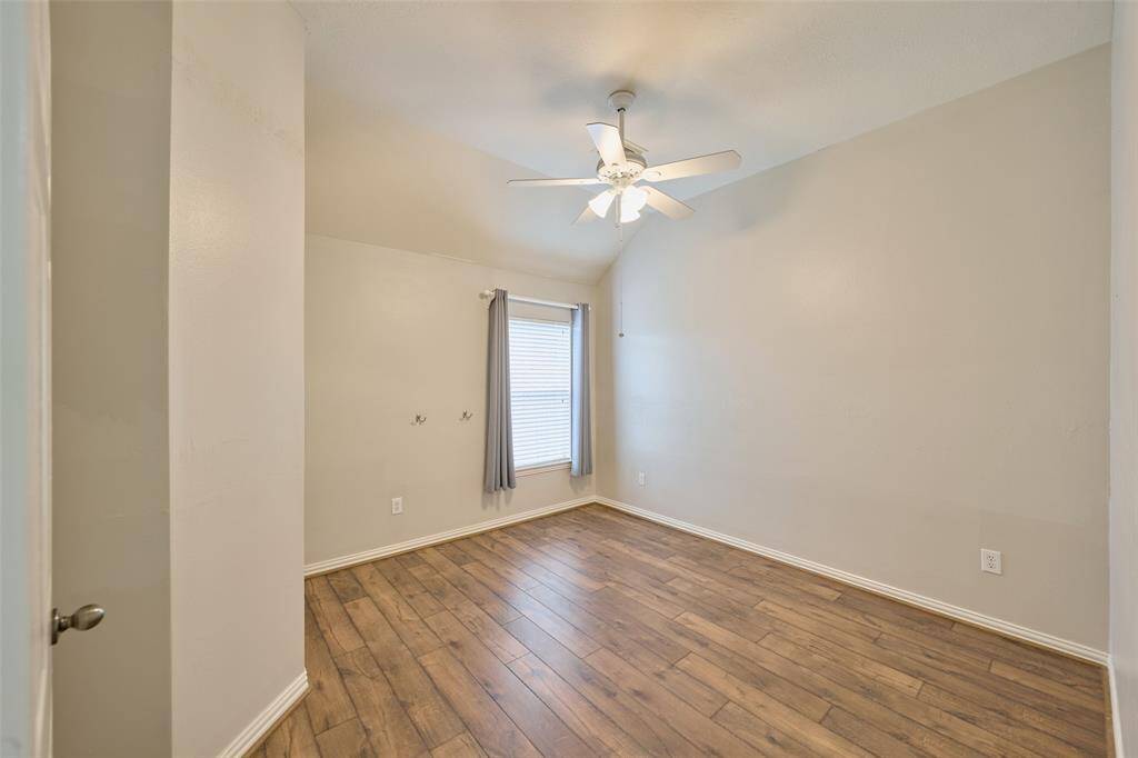 Another spacious secondary bedroom equipped with luxury vinyl plank flooring and a ceiling fan.