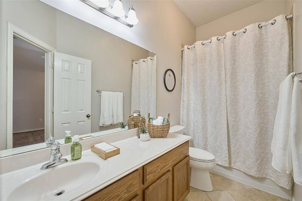 Secondary bathroom featuring ample counter space and a tub/shower combination.