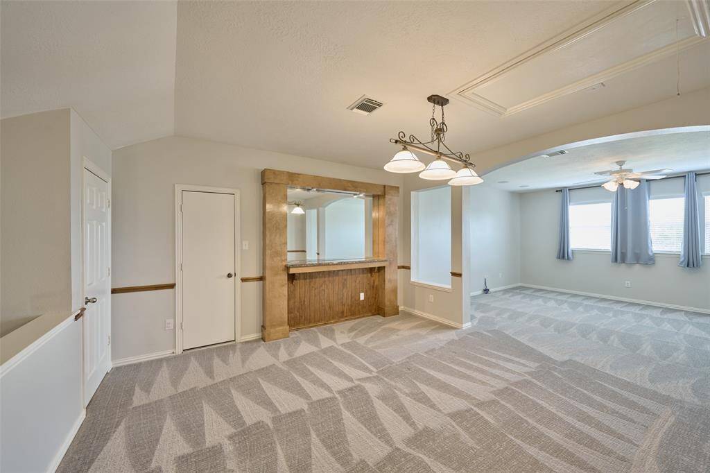 Upstairs, you'll find a game room, ideal for game nights, with plenty of space for a pool table and seating for movie nights.