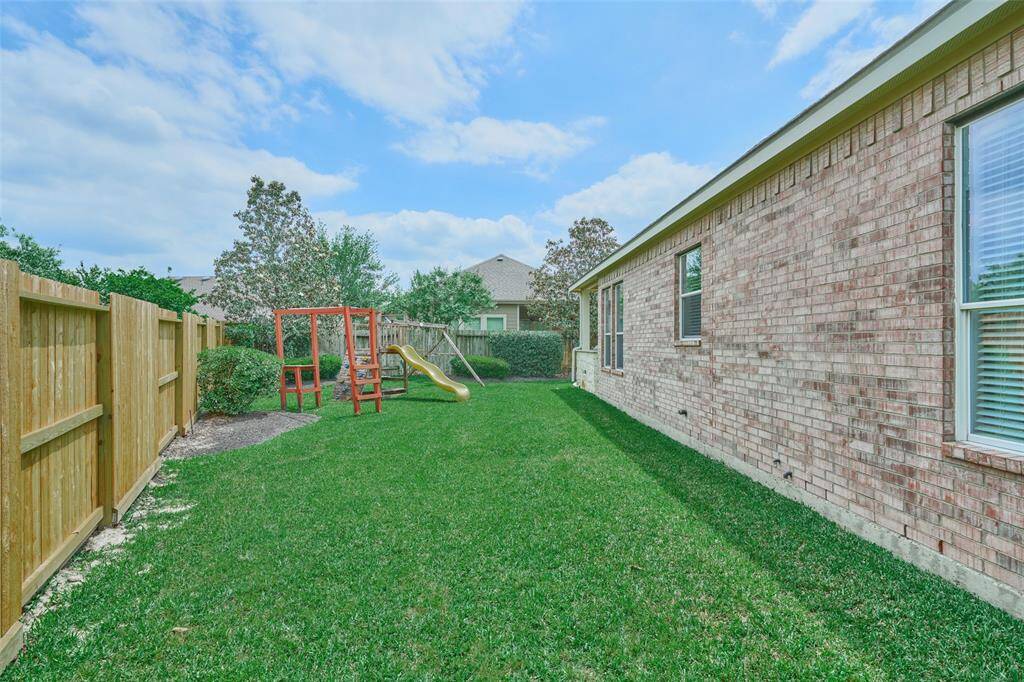 The wooden playset for the children is included in the sale of the home and there is still plenty of yard space available.