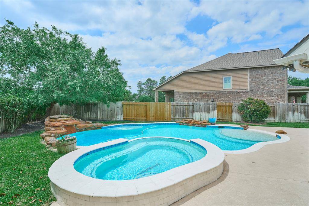 The gunite pool features water elements and a walk-in entrance—it's truly stunning!