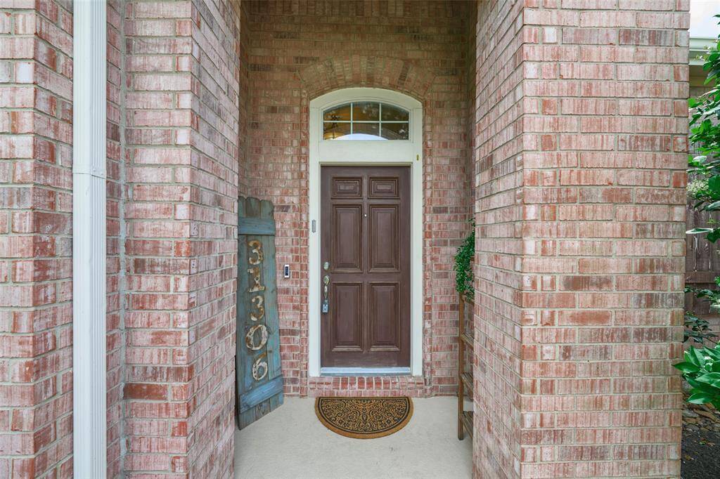 Welcoming covered entryway that invites you to enjoy the charm of the home.