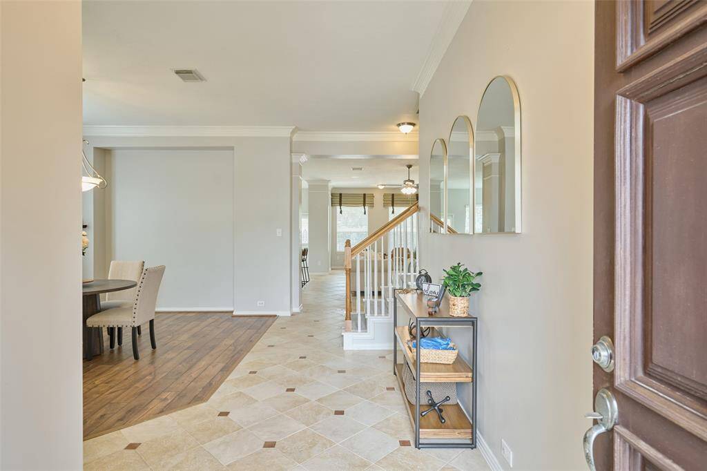 Step inside to an open hallway with one wall, leading to a spacious and open layout that continues throughout the home.