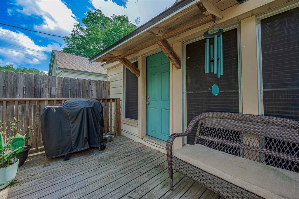 The spacious backyard features a charming wooden deck, ideal for outdoor dining, relaxation, or entertaining, with plenty of room to enjoy the outdoors in comfort.
