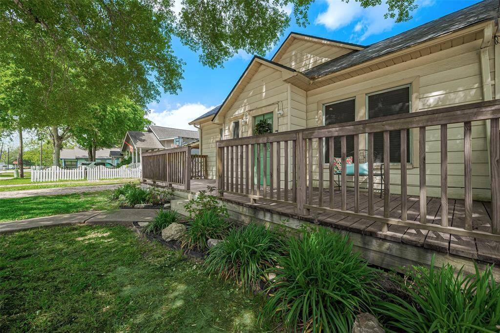 Charming home with a cozy front porch, surrounded by lush greenery. Ideal for relaxing and enjoying the outdoors.