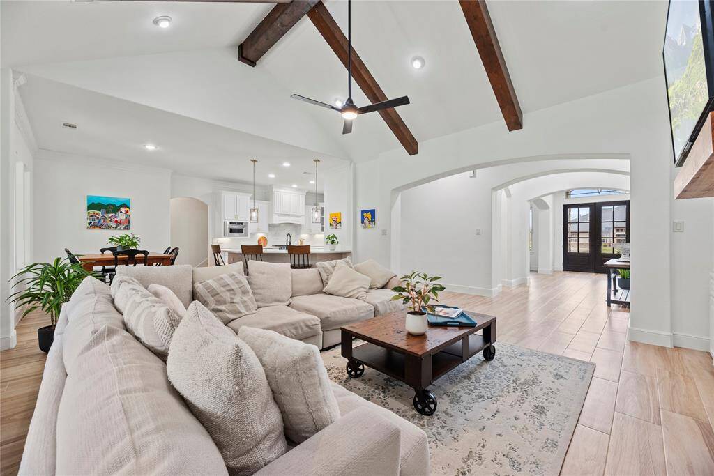 High or intricately designed ceilings can draw the eye upward, adding a sense of grandeur and elegance to the room. The exposed beams and vaulted ceiling create a dramatic focal point that complements the overall aesthetic.
