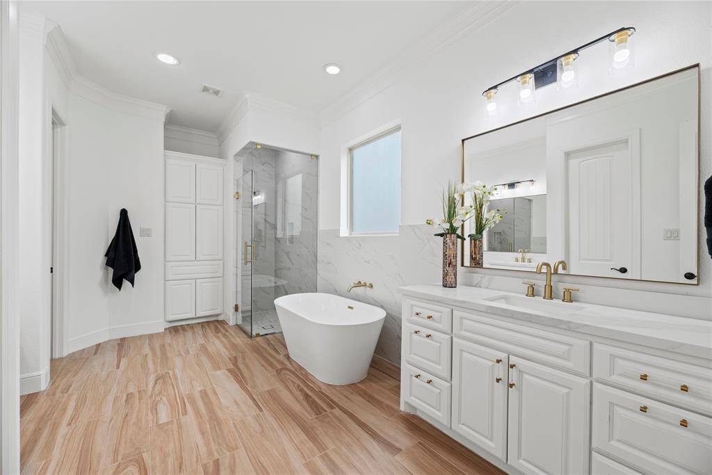 Your primary bath exudes five-star designer flair. Pristine white palette elevates every detail.