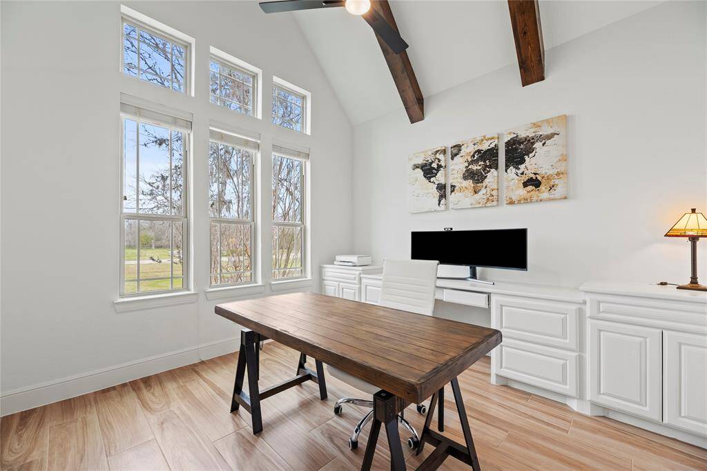 A private study through double glass doors adds a touch of sophistication and privacy to the home. It suggests a space dedicated to concentration, creativity, and productivity. Custom cabinetry and lighting elevate your workspace.