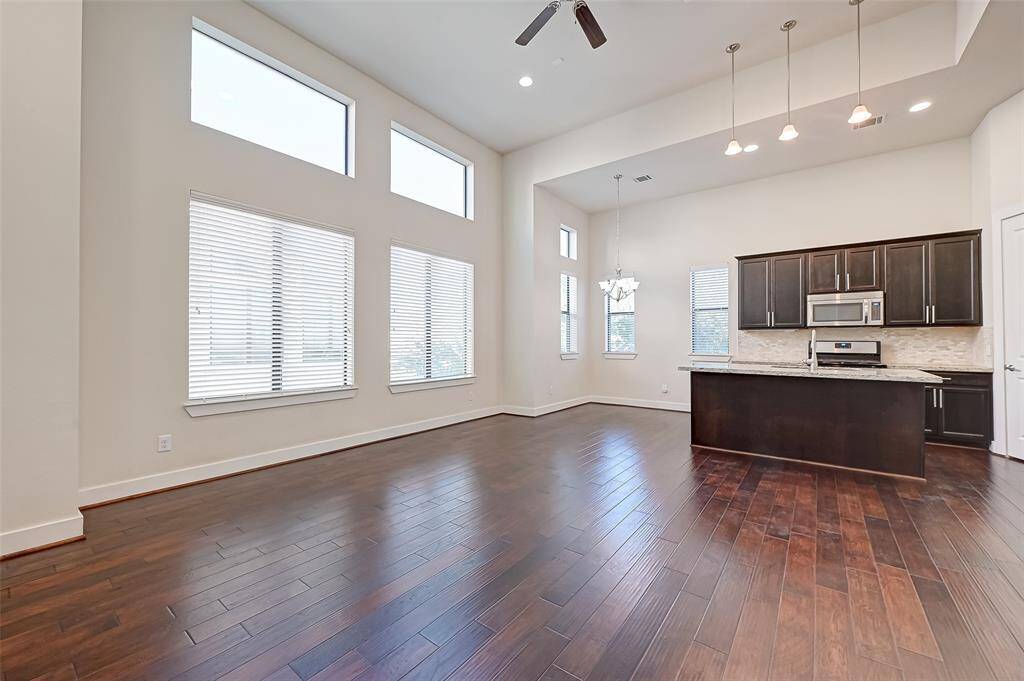 From the living area, you get a clear view of the dining space and modern kitchen, creating a seamless flow perfect for entertaining. The open layout allows for easy conversation and movement throughout the main living space.