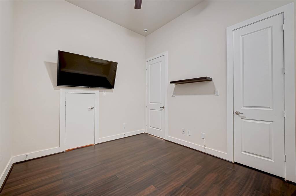 Second bedroom on the first floor features generous closet space and a large window that fills the room with natural light. A perfect setup for a guest room, home office, or additional living space with plenty of flexibility.
