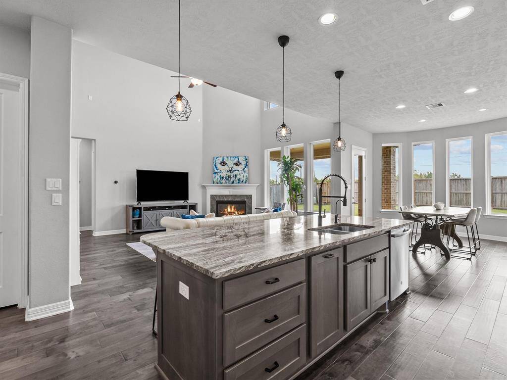 Chef's eat-in island kitchen features 42" cabinets with crown molding, under cabinet lighting, designer backsplash, stainless steel appliances and legthy countertops