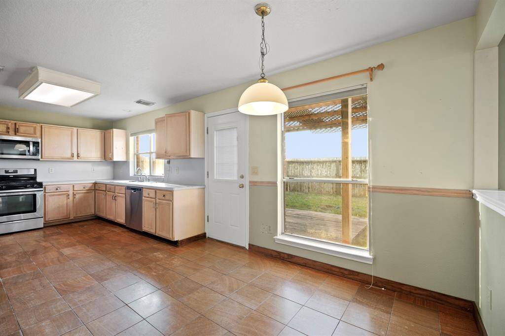 The breakfast nook area opens up to the kitchen and provides a great view of the backyard. Enjoy your morning coffee with this serene view of the backyard. No rear neighbors.