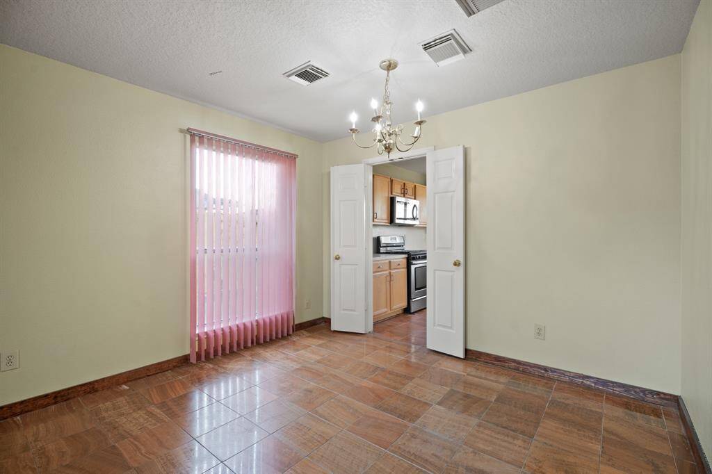 The living room or dining room combo leads to the kitchen separated by double doors.