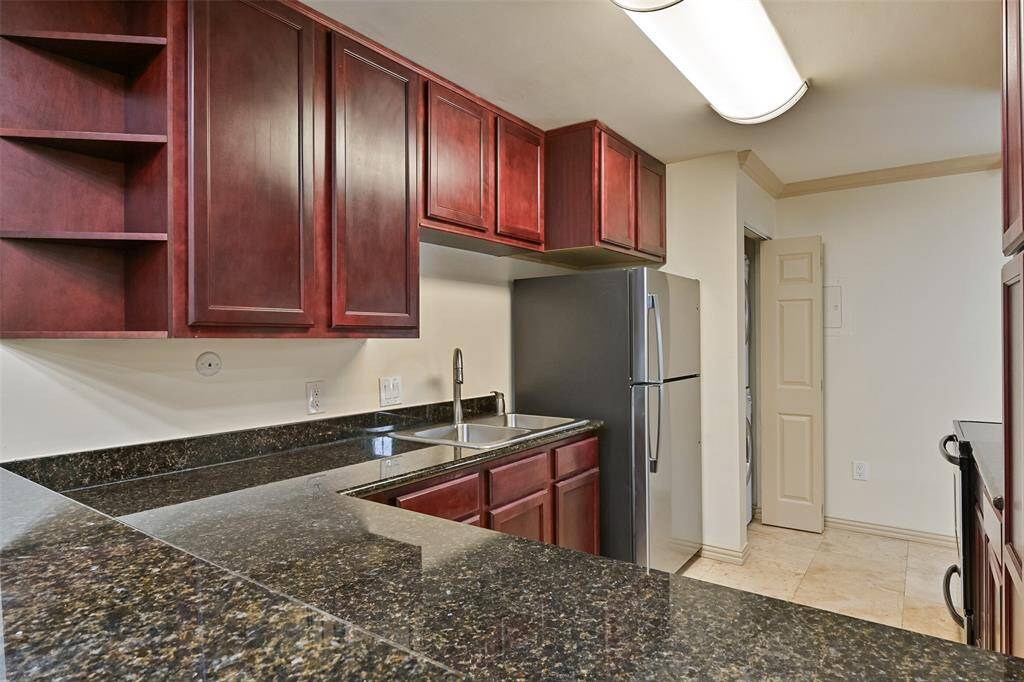 A nice-sized refrigerator refrigerator and ample cabinetry provide excellent storage for all your culinary essentials.