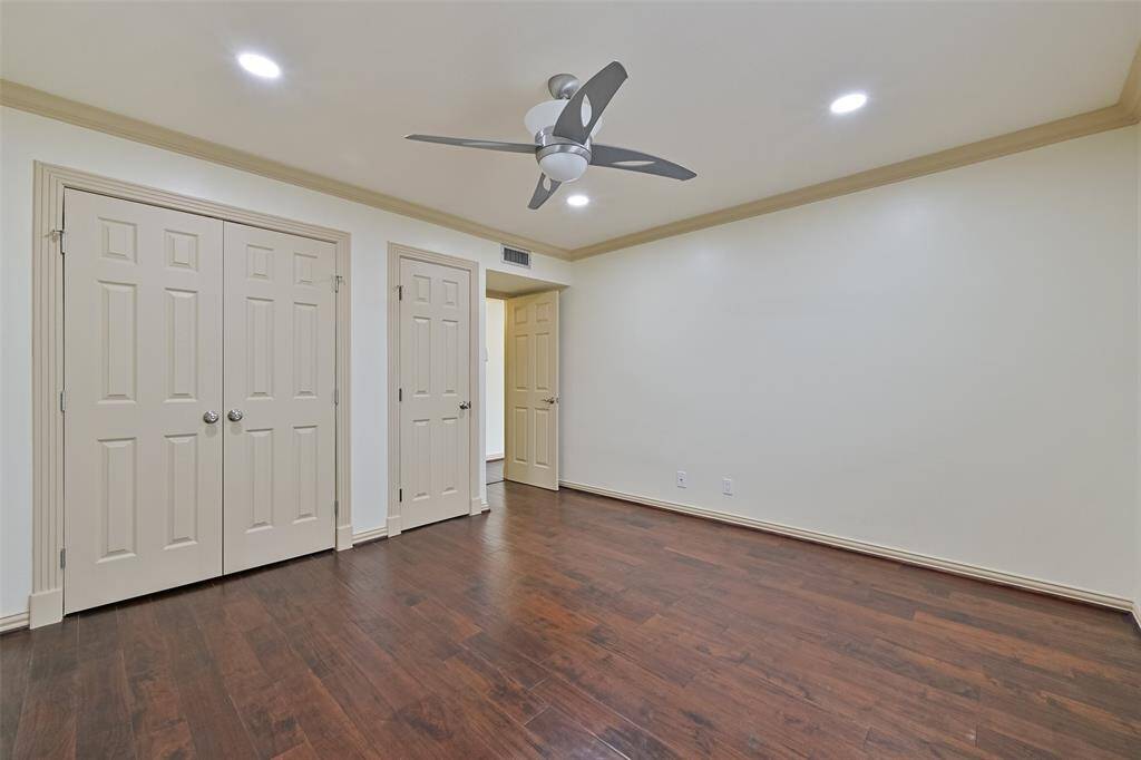 The first bedroom boasts hardwood floors, abundant natural light, and ample closet space.
