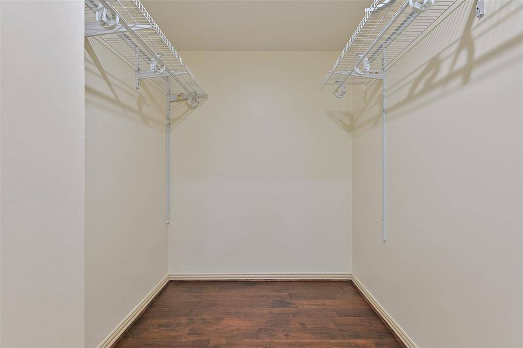 A large walk-in closet provides ample storage and organization.