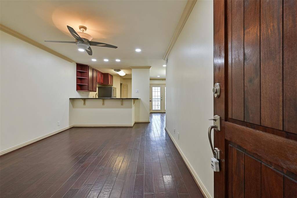 Welcome to Unit #207 at The Excelsior! Step into the spacious living room, where warm hardwood floors create an inviting atmosphere.