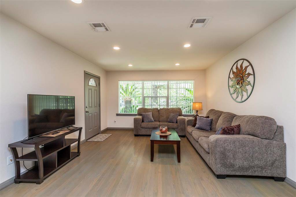 Living room opens to kitchen and breakfast bar area.