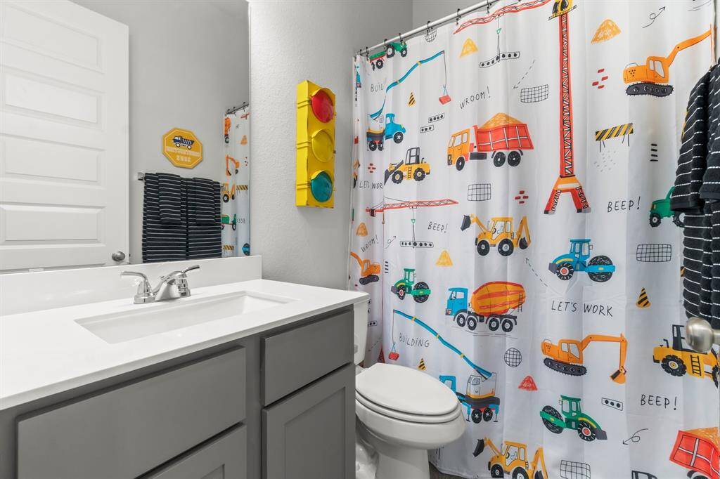 Secondary full bathroom off the kitchen on the first floor.