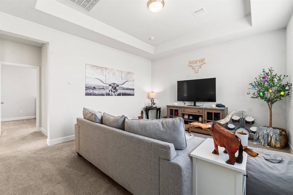 The upstairs game room offers a versatile space perfect for games, media  room or hobbies. Connected is a full bathroom and two bedrooms.