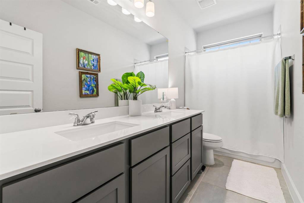 Full bath up stairs. Quartz countertops, double vanity and tub/shower combo.