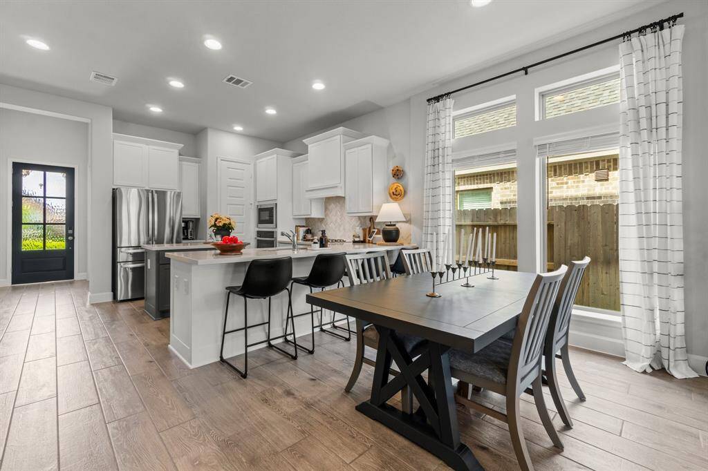 Breakfast bar with extra seating. perfect for causal meal or morning coffee. The overall design is airy. inviting and ideal for both cooking and entertaining.