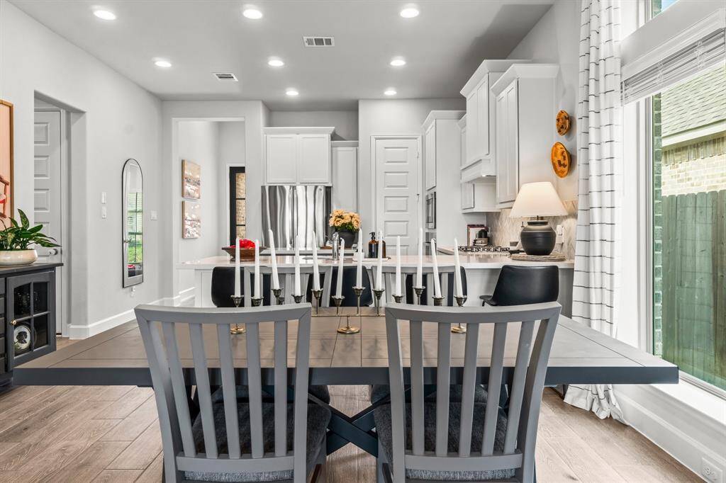 To the left provides access to the garage, secondary bedroom and full bath. Dinning room and kitchen open up to the Entry and office.