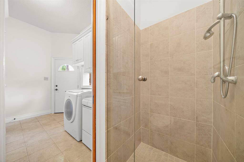 Bath off laundry featuring a shower. Great for dog washing!