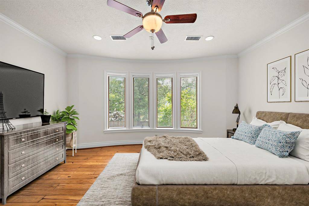 Primary Bedroom with pine floors. Virtually Staged.